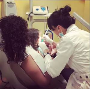 Child receiving a pediatric dental cleaning and examination at Sachar Dental NYC. Back-to-School Dental Tips