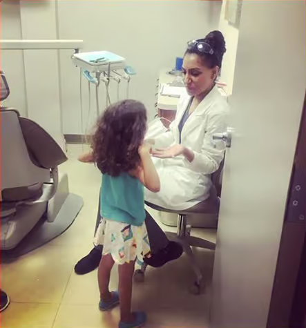 Talking to a child at a dental clinic.