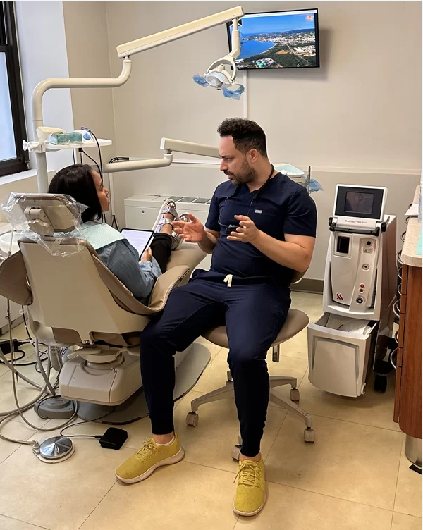 Dr, Cohen discussing LANAP laser surgery NYC with a patient at Sachar Dental