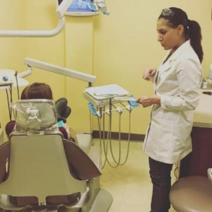 A dentist consulting with a patient in preparation for a wisdom tooth removal procedure